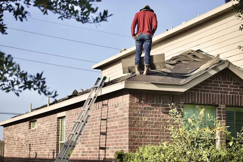 Professional roofer working on a residential roof in Dalhart